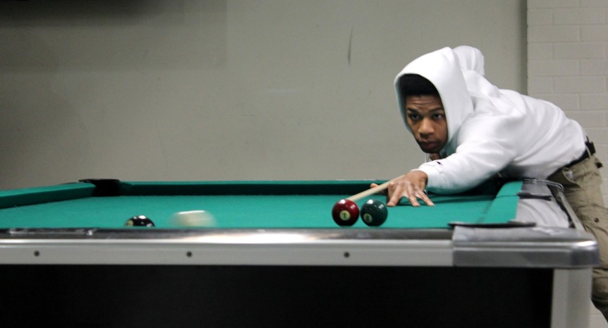 Undergrad student Irvin Phillips shoots the winner point in a game of pool in the newly renovated WSU student center. 